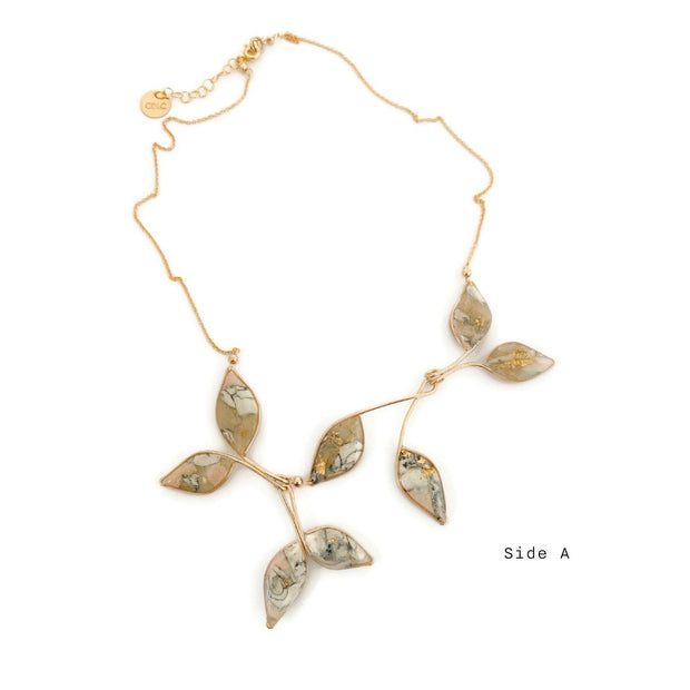 a necklace with marble filled leaves with a gold chain on a white background "Side A"