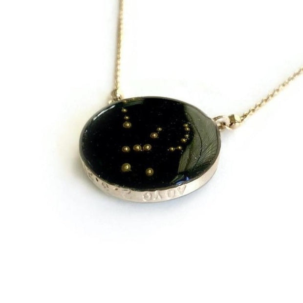 Gold pendant with night sky background and Orion Constellation made from glass beads inset. Custom stamping along the pendant edge with AOYG and the date 2.6.21